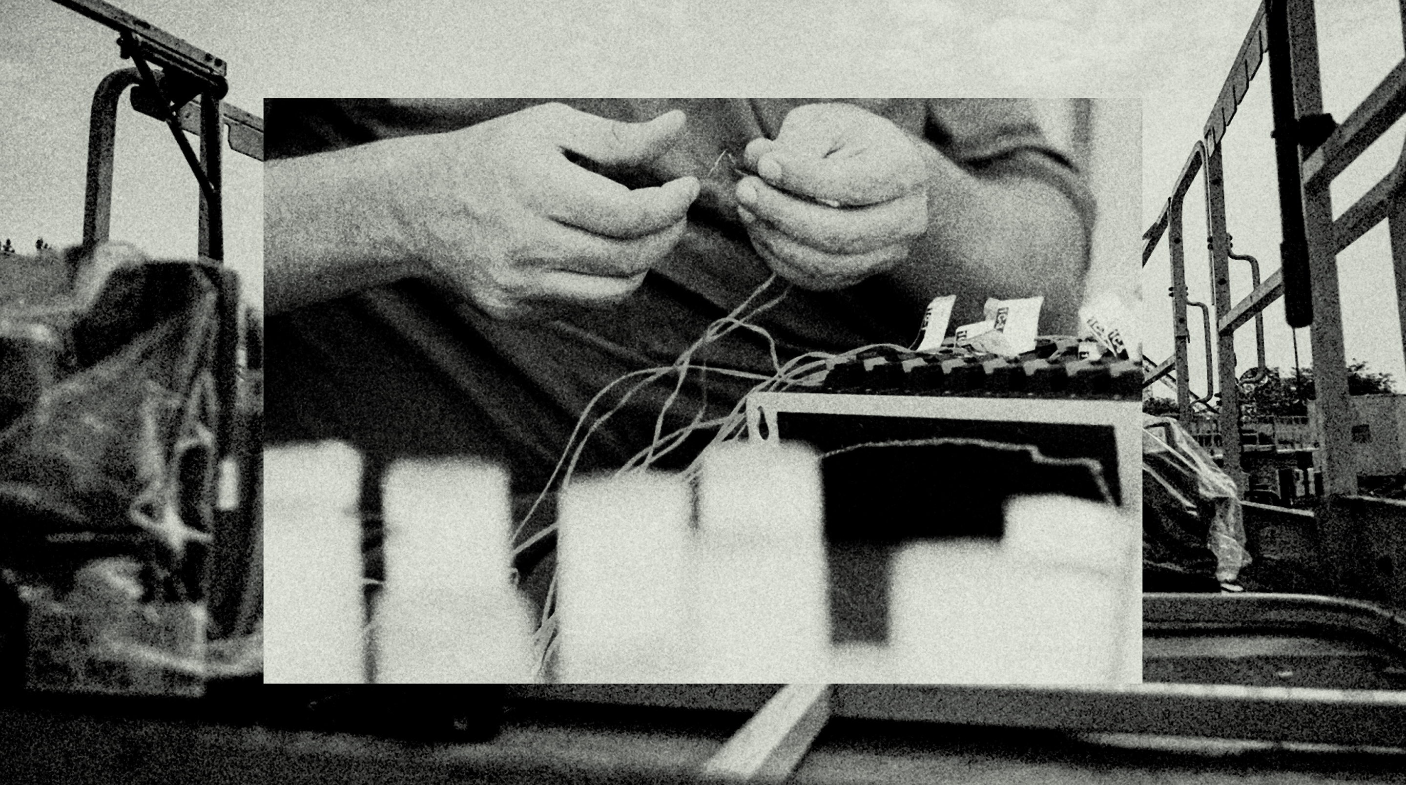 Hands wiring together fuses for a firework mortar