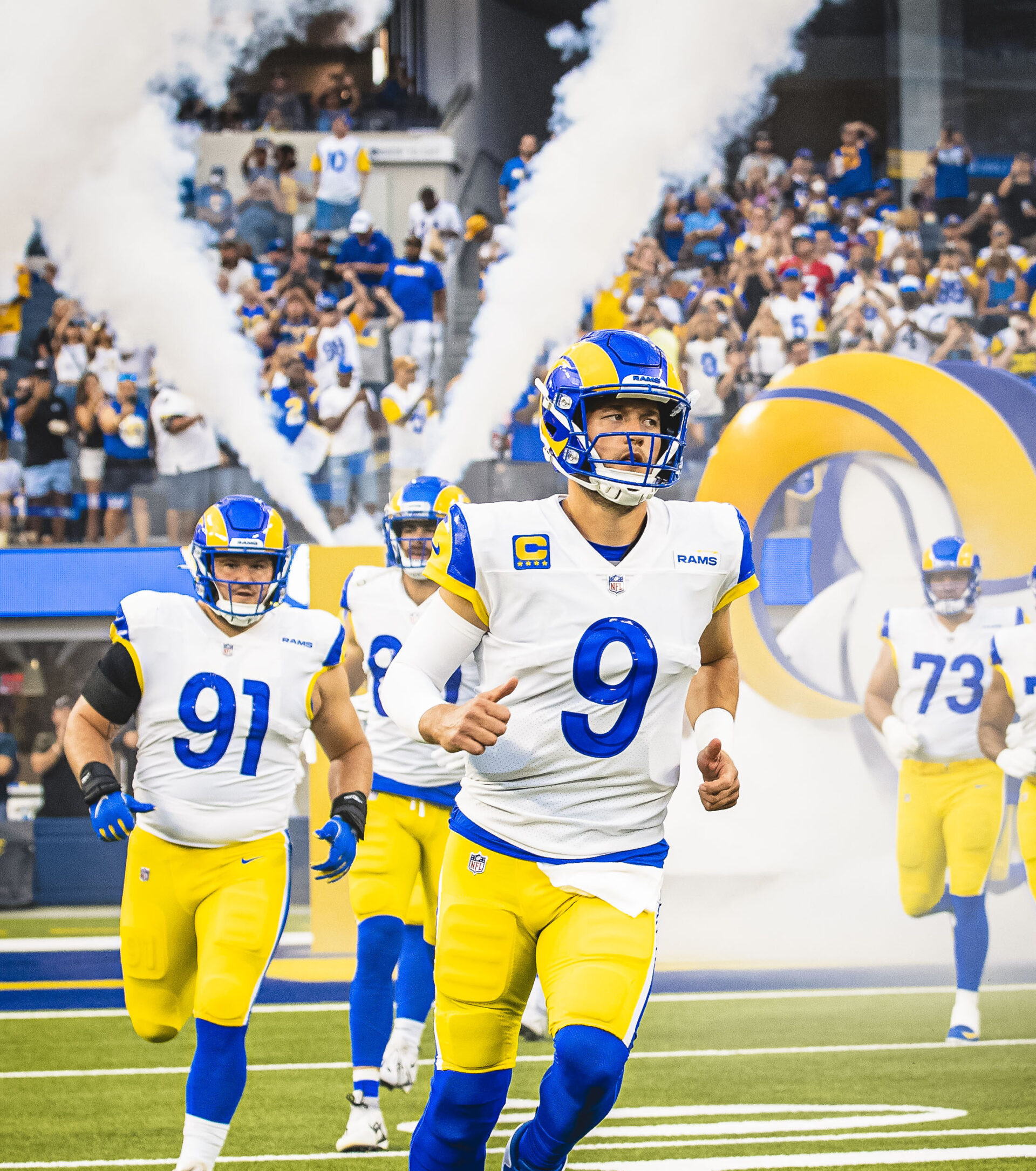 The Los Angeles Rams with atmospheric smoke emerging behind them