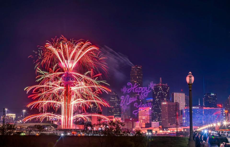 Fireworks shooting out of Reunion Tower, Dallas skyline in the background